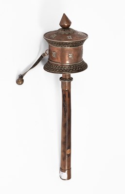 Lot 594 - A Tibetan copper and white metal prayer wheel