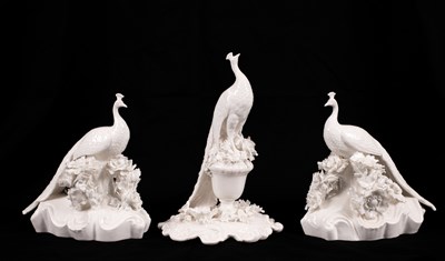 Lot 541 - Two Coalport white glazed peacocks