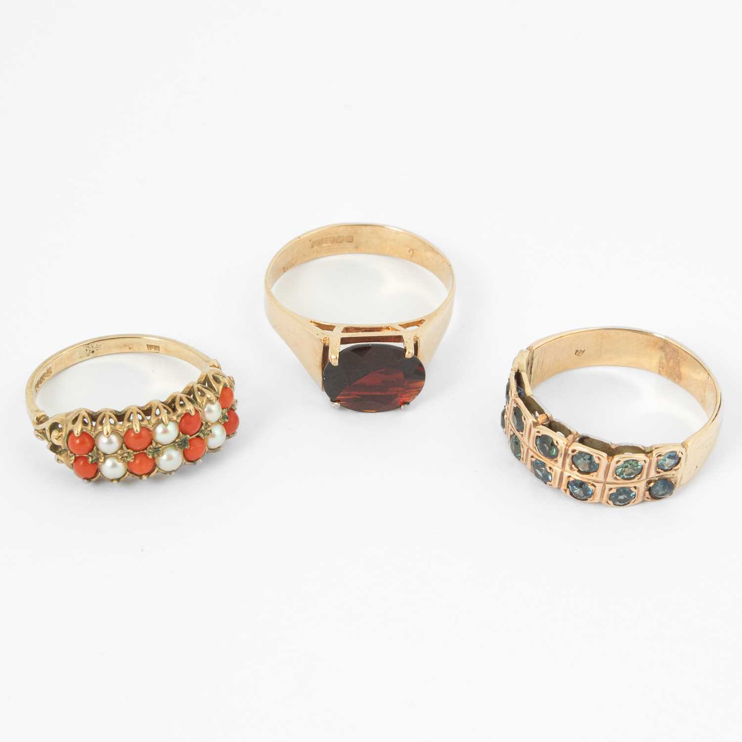 Lot 115 - Three yellow metal gem set dress rings