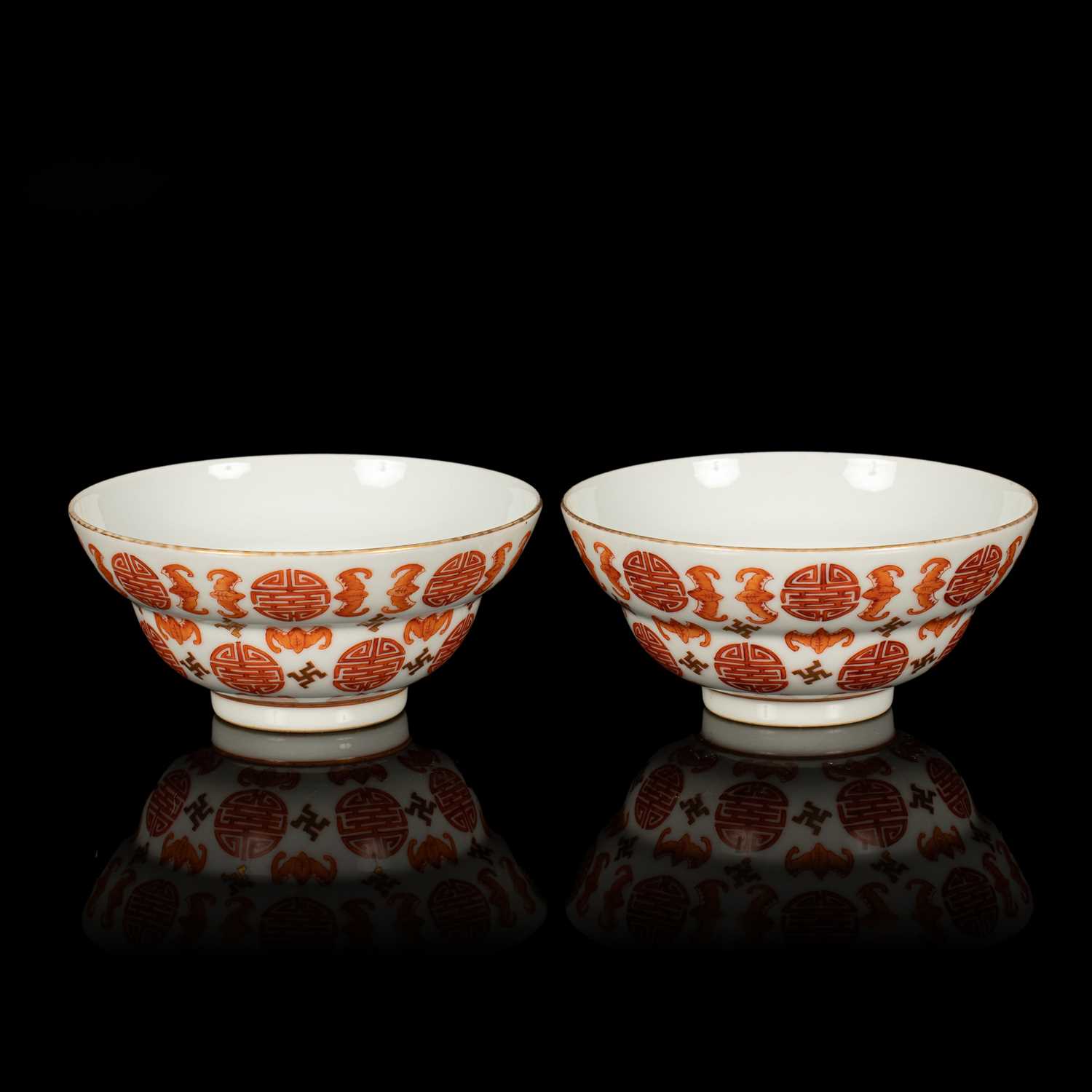 Lot 624 - A pair of Chinese iron red and gilt decorated 'Bats and Shou-character' bowls