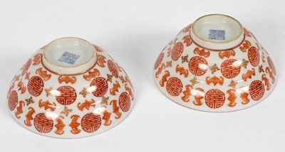 Lot 624 - A pair of Chinese iron red and gilt decorated 'Bats and Shou-character' bowls