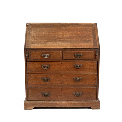 Lot 556 - A late 19th/early 20th Century oak bureau