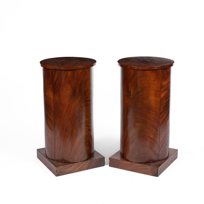 Lot 655 - A pair of mahogany cylinder bedside tables