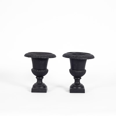 Lot 523 - A pair of small cast iron urns