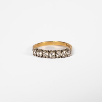 Lot 11 - An 18ct yellow gold and diamond seven stone half eternity ring