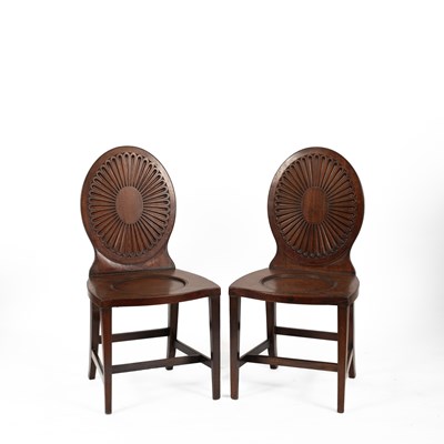 Lot 576 - A pair of George III mahogany hall chairs