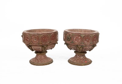 Lot 522 - A pair of rouge marble circular pedestal urns