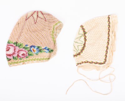 Lot 828 - Two European beaded baby's caps