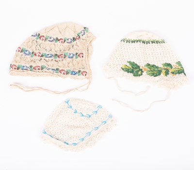 Lot 830 - Three European beaded baby's caps