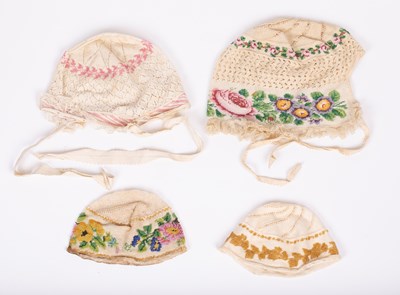 Lot 834 - Four European beaded baby's caps