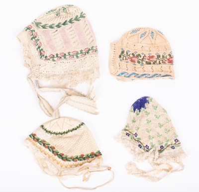 Lot 836 - Four European beaded baby's caps