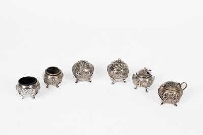 Lot 82 - Two Eastern white metal three-piece cruet sets