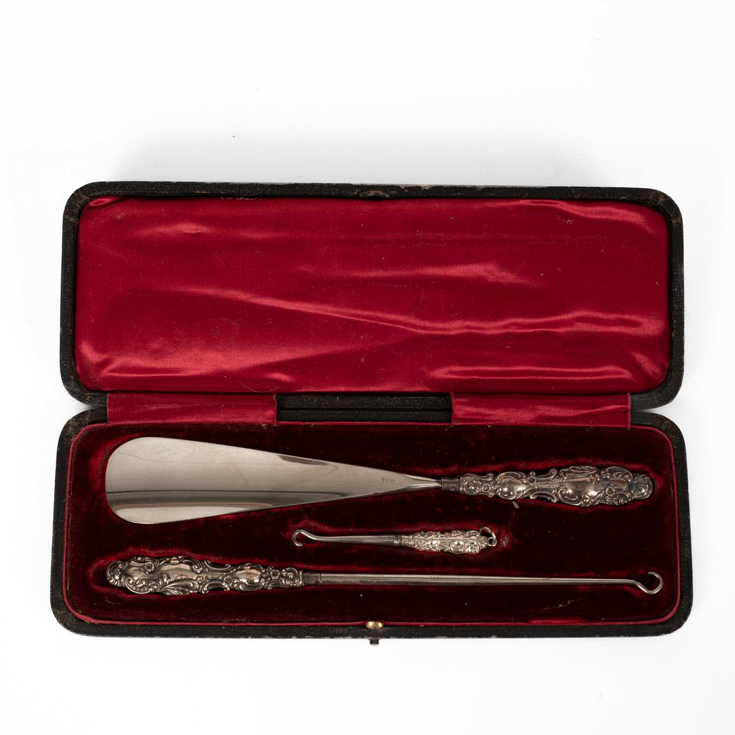 Lot 67 - An Edwardian silver-handled shoe horn and two button hooks