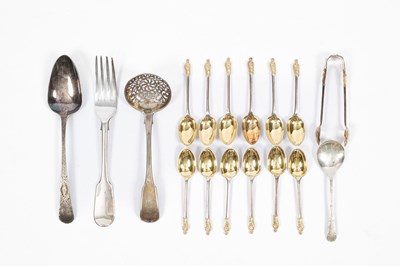 Lot 88 - A set of twelve Victorian silver and silver-gilt apostle top teaspoons and the matching tongs