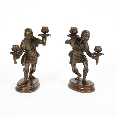 Lot 542 - A pair of French bronze figurative candlesticks