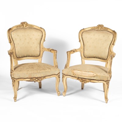 Lot 179 - A pair of Louis XV style cream painted and parcel gilt open armchairs