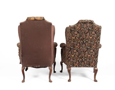 Lot 29 - A pair of upholstered wingback armchairs of Queen Anne design