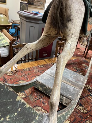 Lot 679 - An early carved and painted rocking horse