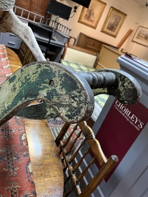 Lot 679 - An early carved and painted rocking horse