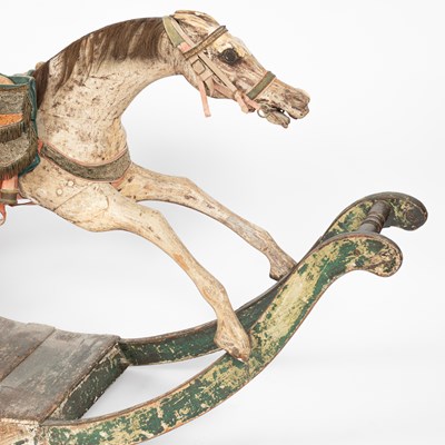 Lot 679 - An early carved and painted rocking horse