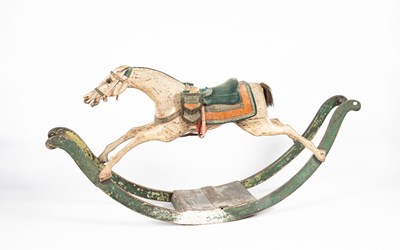 Lot 679 - An early carved and painted rocking horse