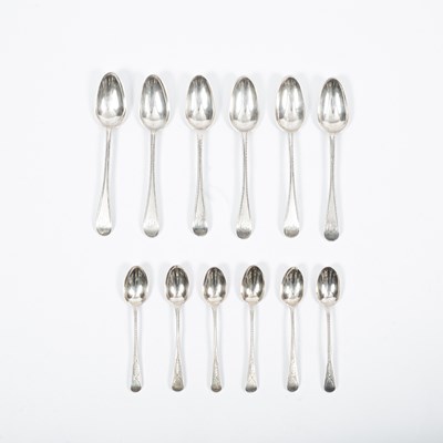 Lot 124 - A closely matched set of six George III silver feather-edge dessert spoons