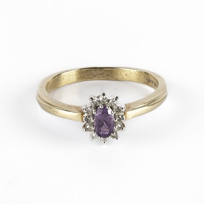 Lot 228 - A 9ct yellow gold amethyst and diamond cluster ring