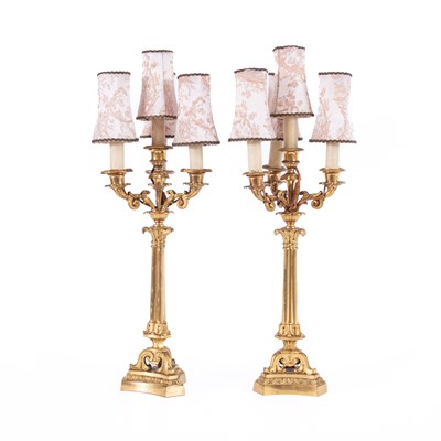 Lot 885 - A pair of gilt metal four branch candlesticks