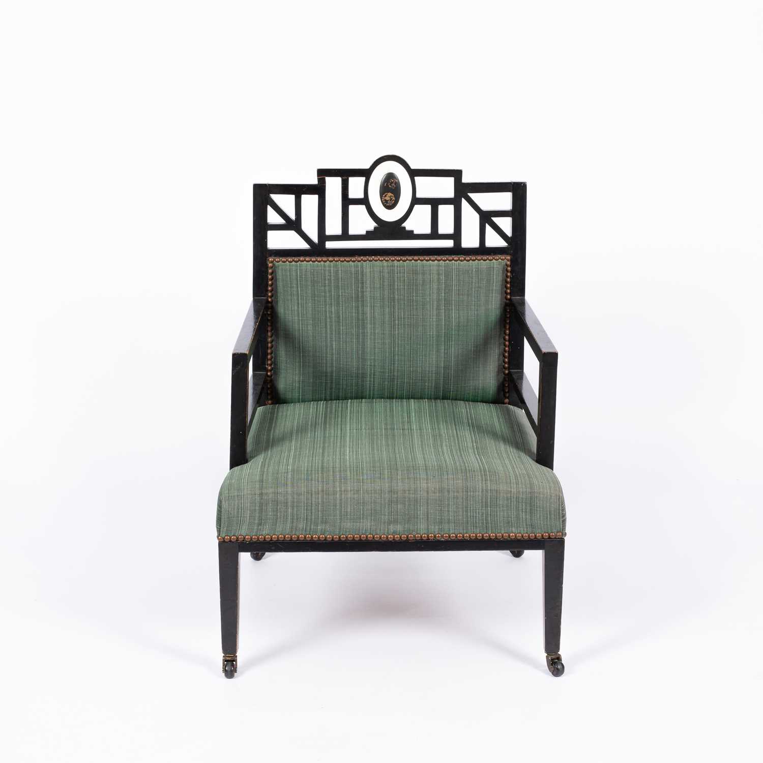 Lot 50 - An Aesthetic movement ebonised open armchair