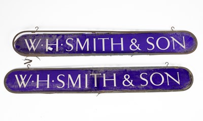 Lot 53 - Two ovoid W. H. Smith & Son reverse painted blue glass signs
