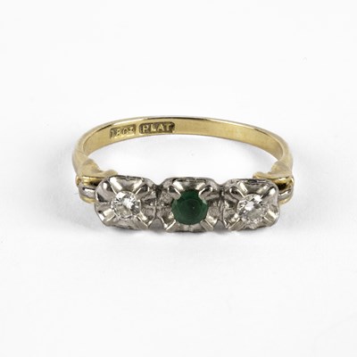 Lot 85 - An emerald and diamond three-stone ring