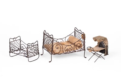 Lot 493 - An English dolls' house wirework bed and two wirework cradles