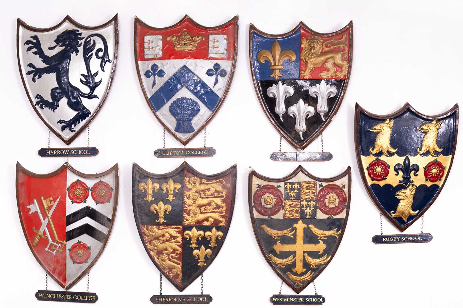 Lot 2 - A collection of painted plaster school heraldic shields