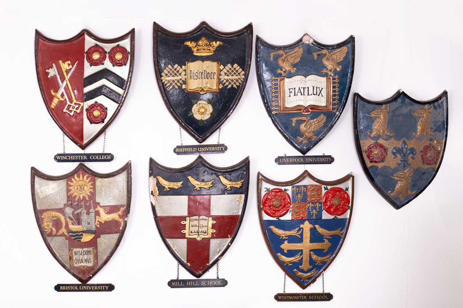 Lot 3 - A collection of painted plaster school and university heraldic shields