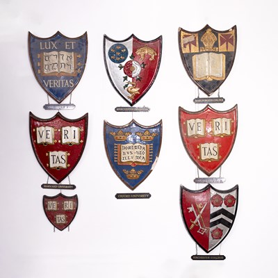 Lot 5 - A collection of painted plaster university heraldic shields