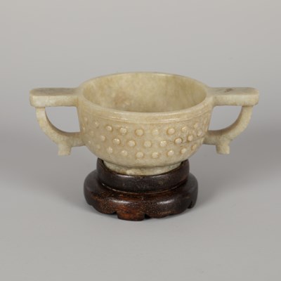 Lot 249 - A Ming style celadon jade two-handled cup