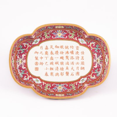 Lot 212 - A Chinese famille rose ruby ground imperially inscribed quadrilobed tray