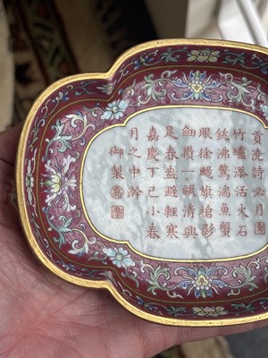Lot 212 - A Chinese famille rose ruby ground imperially inscribed quadrilobed tray