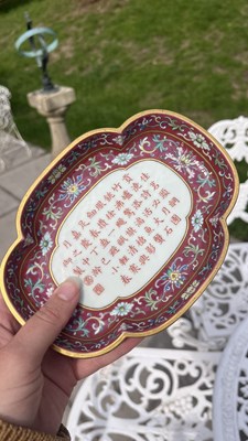 Lot 212 - A Chinese famille rose ruby ground imperially inscribed quadrilobed tray