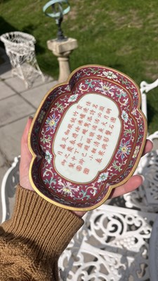 Lot 212 - A Chinese famille rose ruby ground imperially inscribed quadrilobed tray