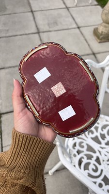Lot 212 - A Chinese famille rose ruby ground imperially inscribed quadrilobed tray