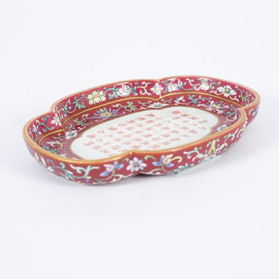 Lot 212 - A Chinese famille rose ruby ground imperially inscribed quadrilobed tray
