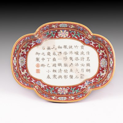 Lot 213 - A Chinese famille rose ruby-ground imperially inscribed quadrilobed tray