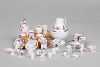 Lot 597 - A group of German milk glass dolls' house tea wares
