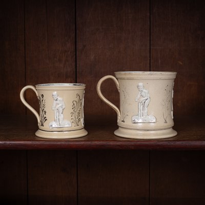 Lot 177 - Two Staffordshire pottery relief moulded mugs decorated with cricketers