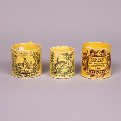 Lot 684 - Three early 19th Century yellow ground earthenware miniature mugs