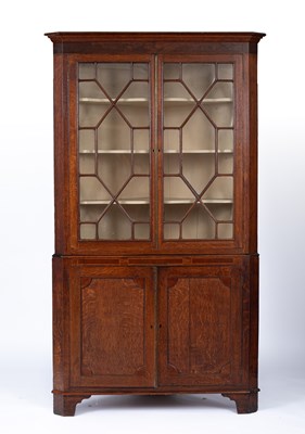 Lot 759 - A George III oak corner cupboard
