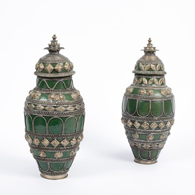 Lot 873 - A pair of Moroccan pottery vases and covers