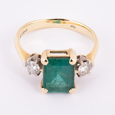 Lot 3 - An 18ct yellow gold emerald and diamond three-stone ring