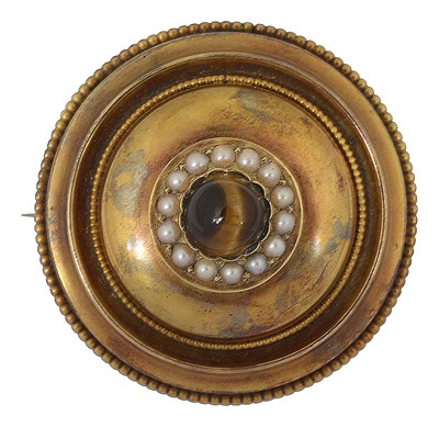 Lot 665 - A Victorian yellow metal tiger's eye and seed pearl target brooch
